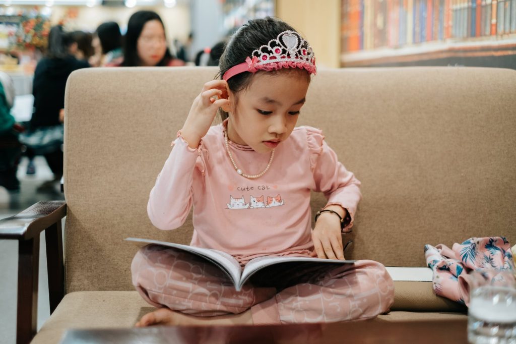 cute little girl reading book